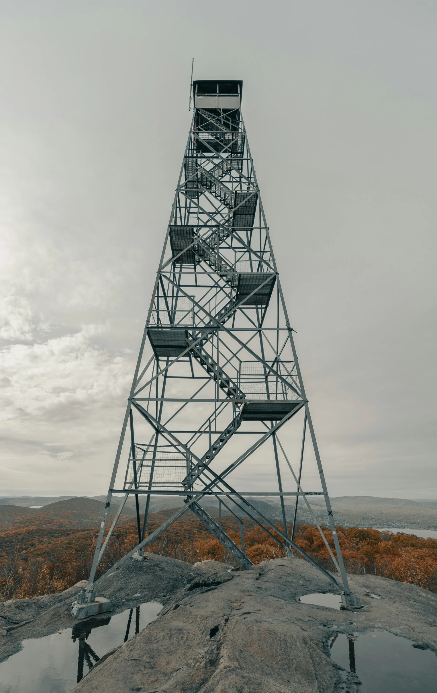 an abandoned fire escape tower sitting on the edge of a mountain