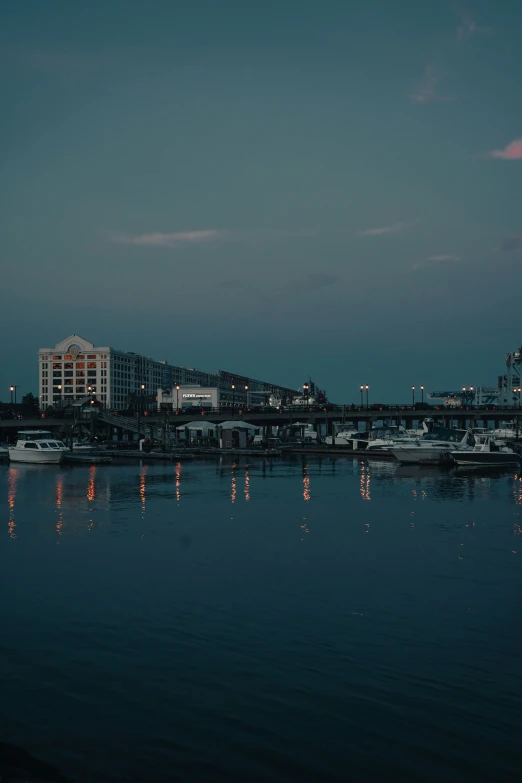 an image of a city at night with lights reflected in the water