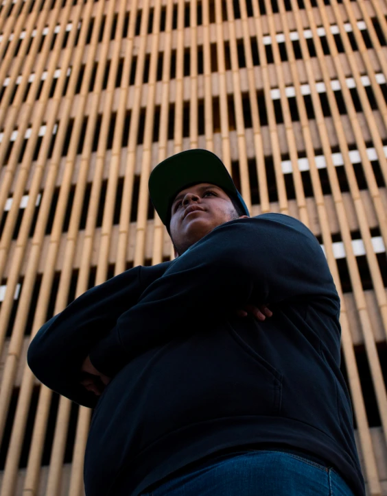 a person leaning on the side of a building