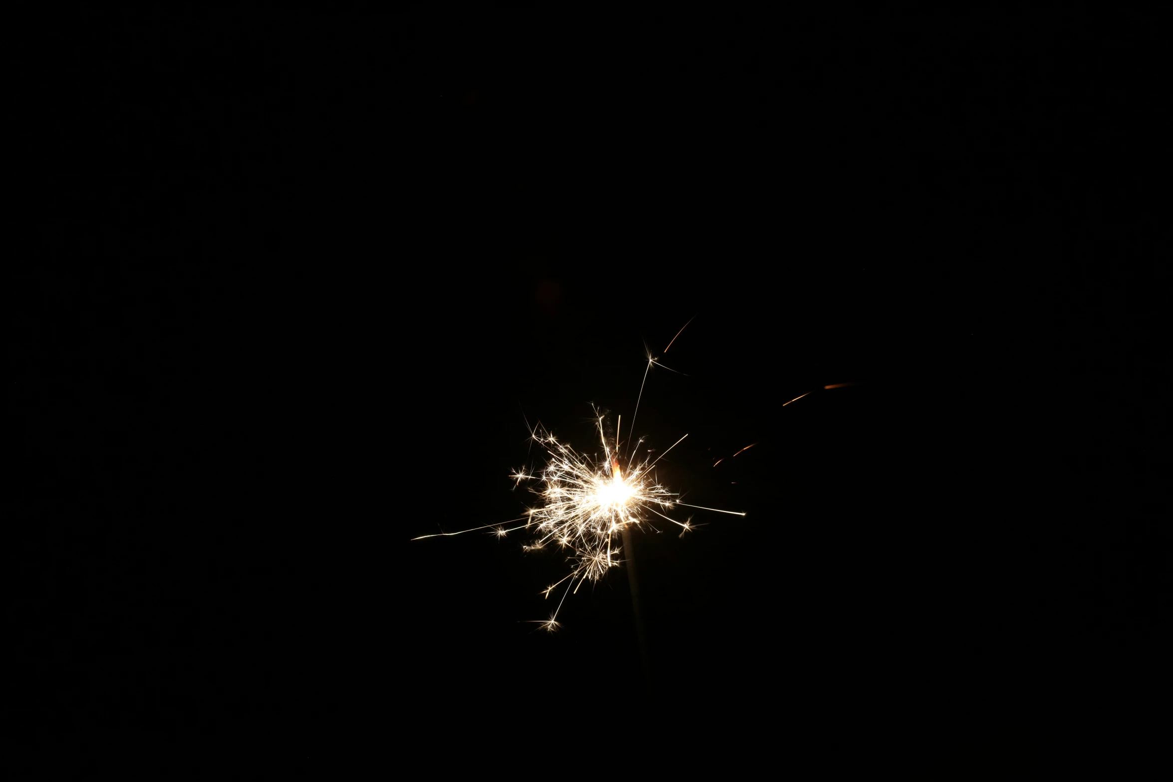 sparkler with some sort of star on it in the dark