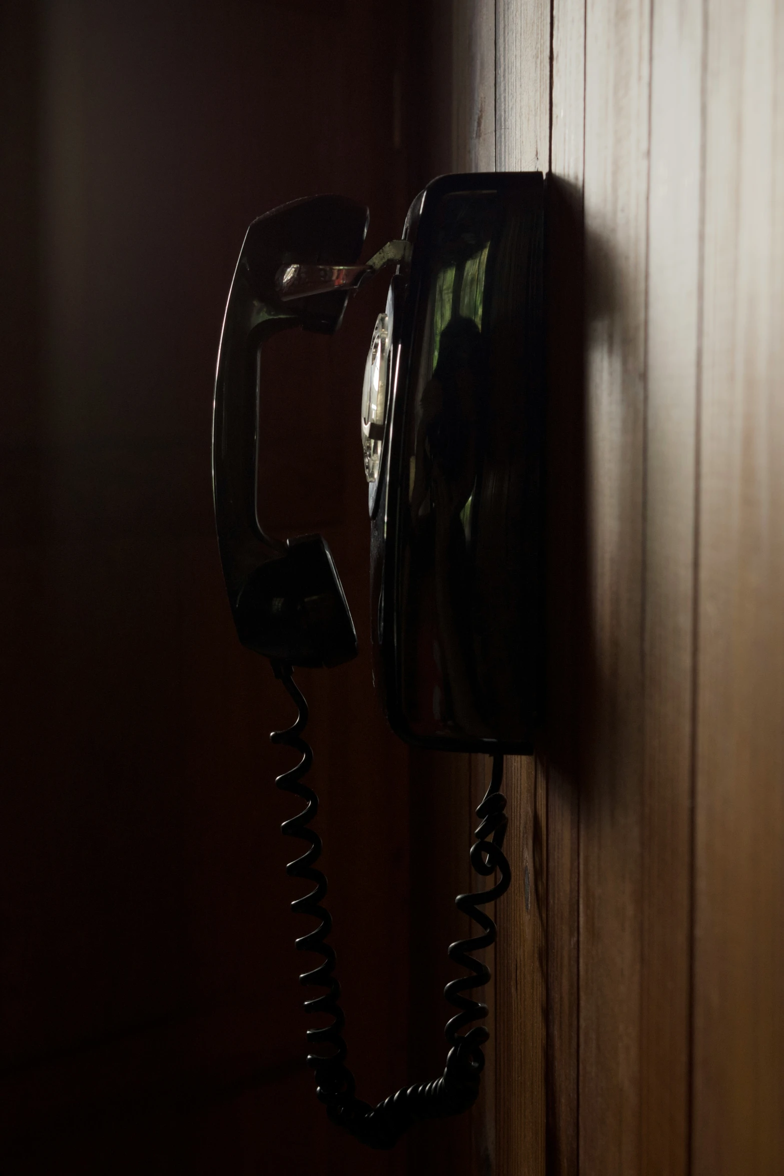 the old fashioned telephone is attached to a wood wall