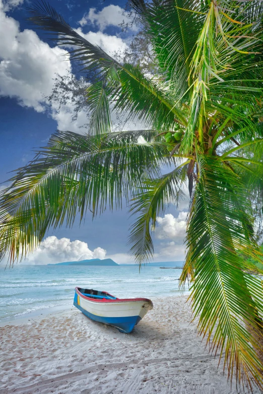 there is a boat sitting on the sand at the beach