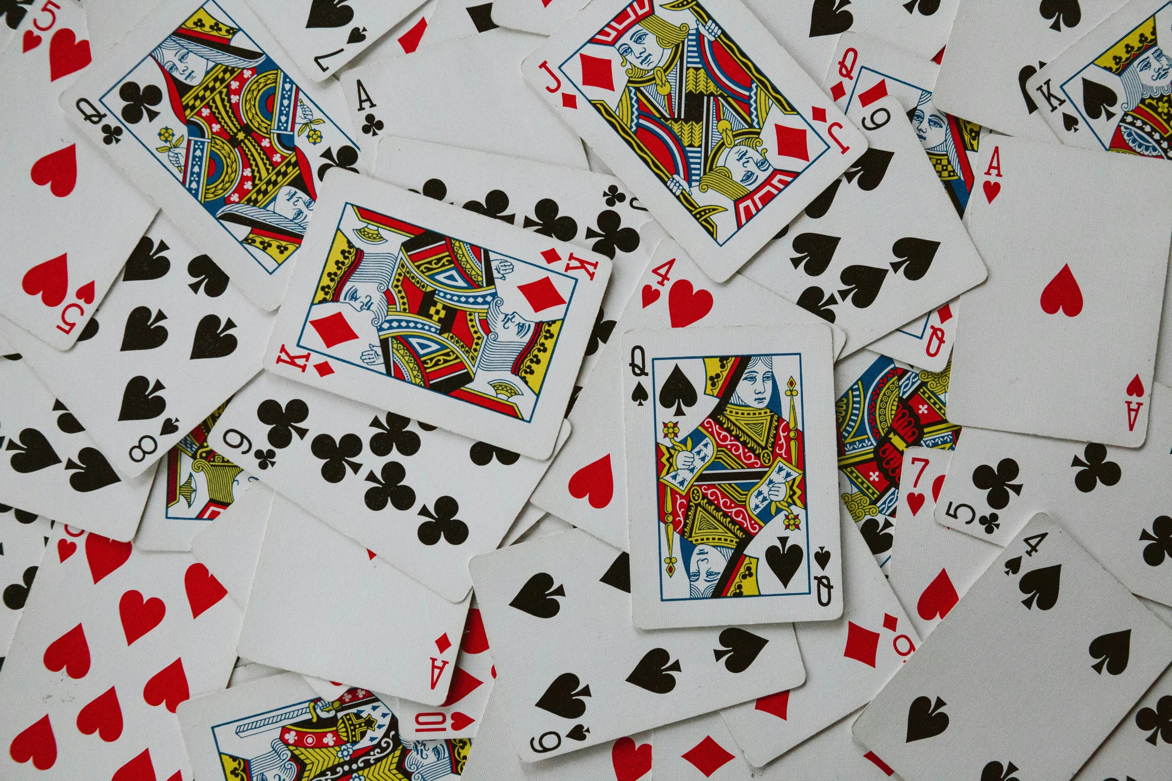 several playing cards have been scattered in an orderly manner