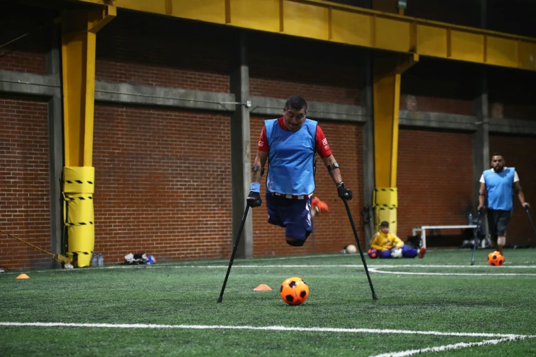 a soccer player walking along with crutches