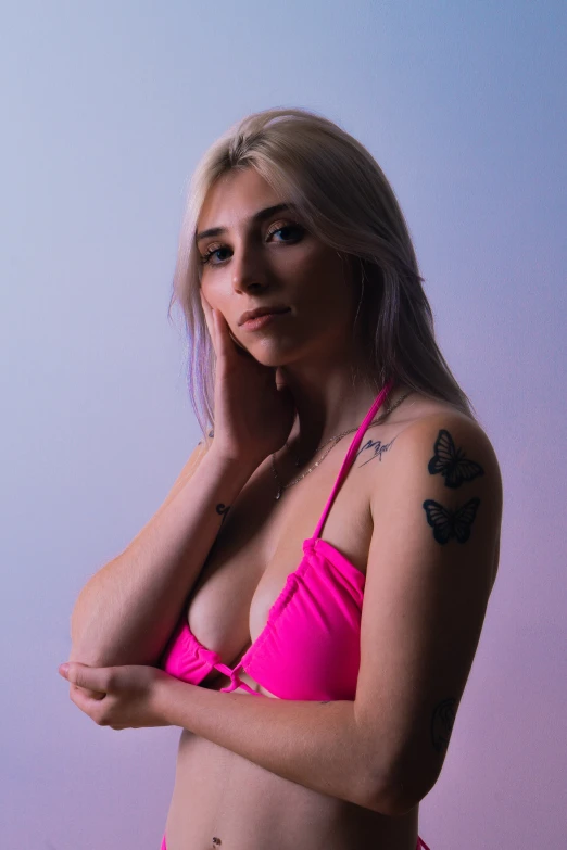 a woman with erfly tattoo and a pink bikini