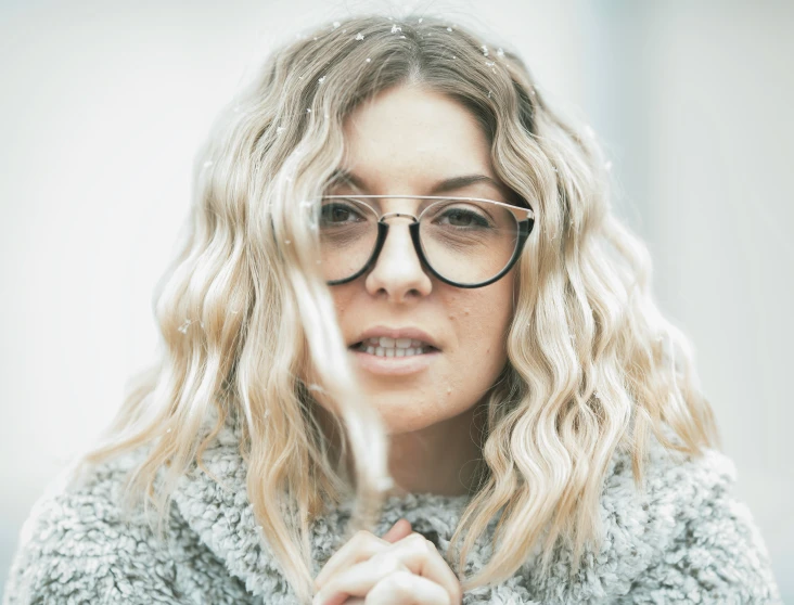 a woman with a round frame and a gray fuzzy coat