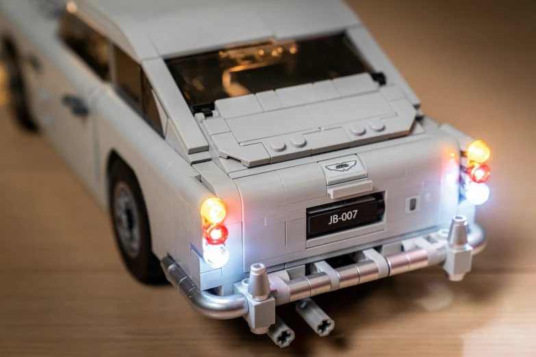 a white lego car with two lights