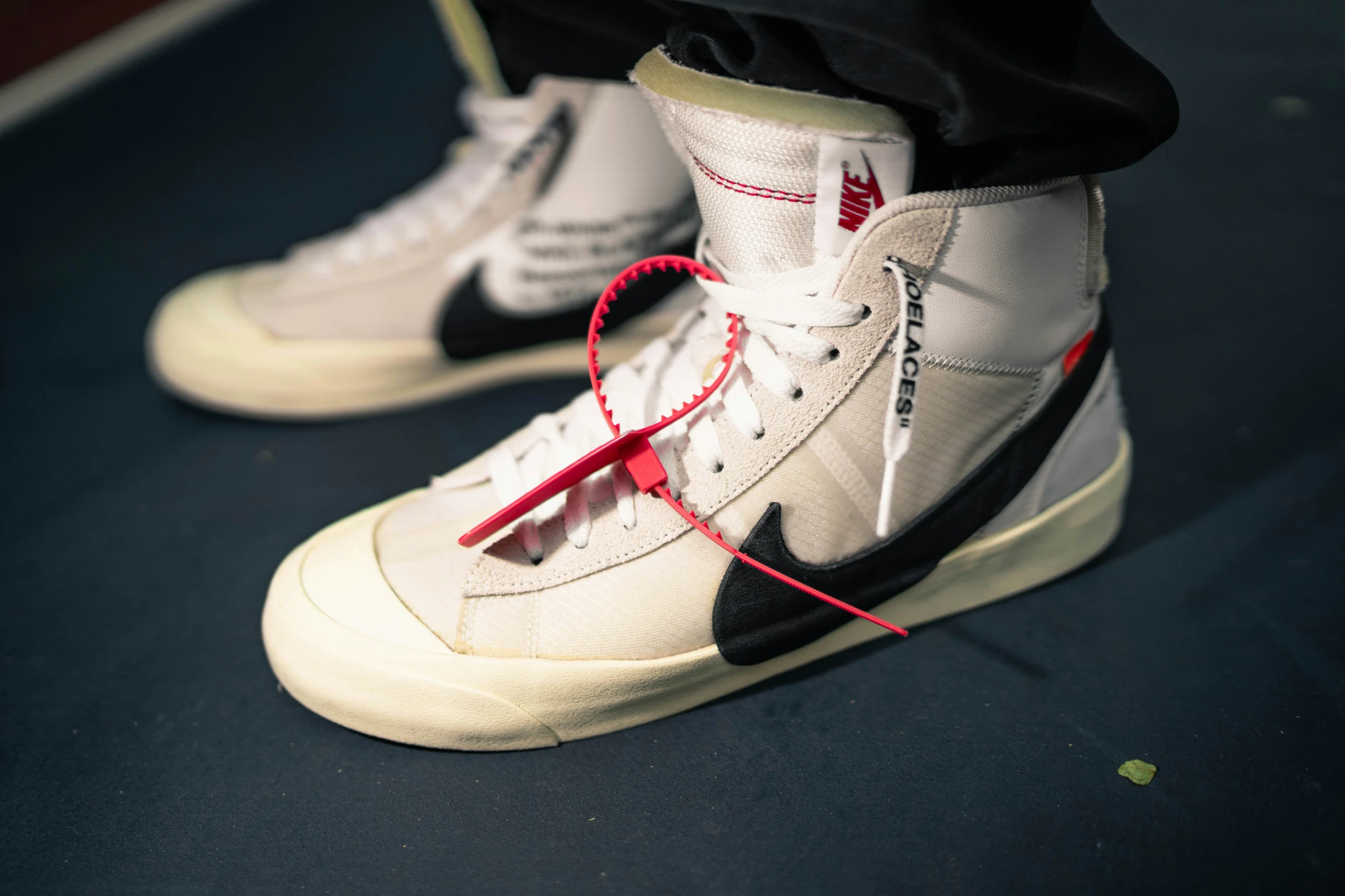 the shoes are wearing white and red laces