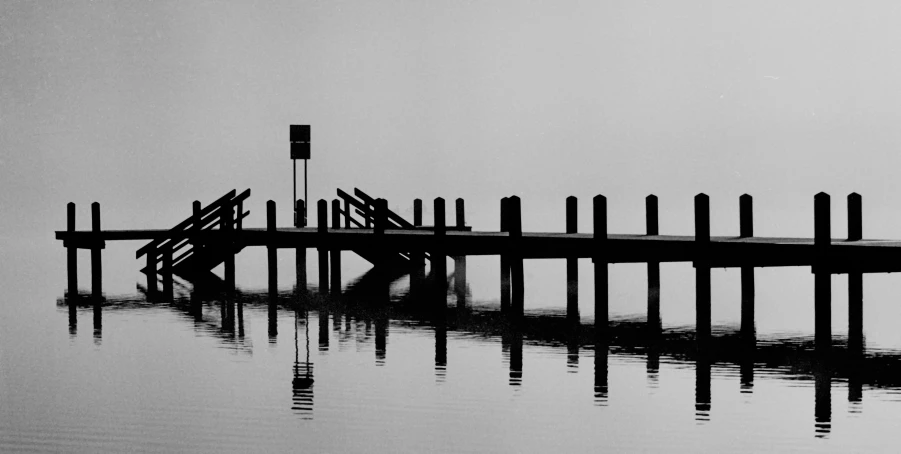 black and white pograph of a dock in water
