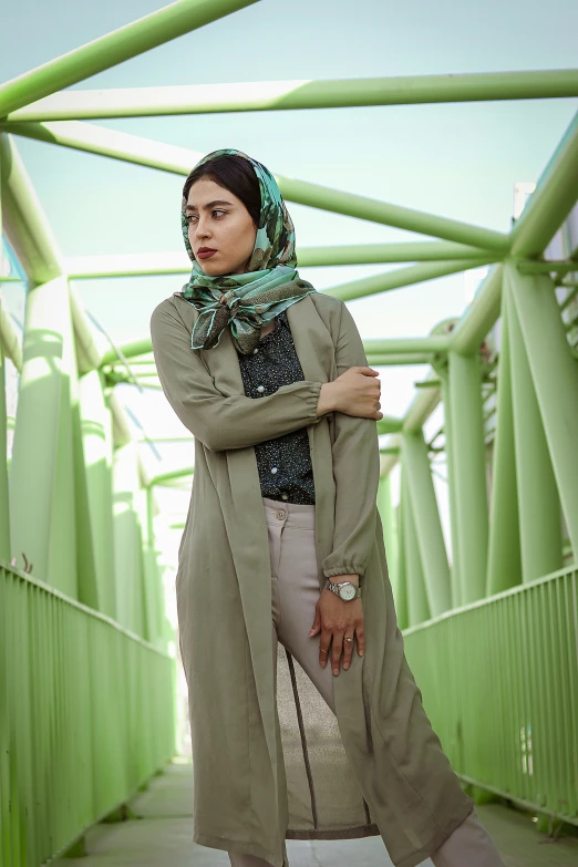 the woman is standing alone wearing a scarf