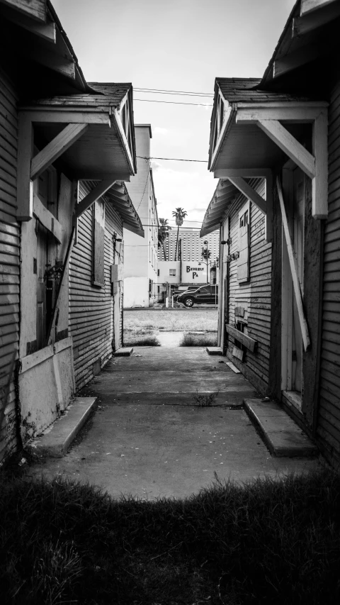 black and white po of an alley between buildings