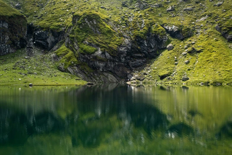 a couple of mountains reflecting in the lake