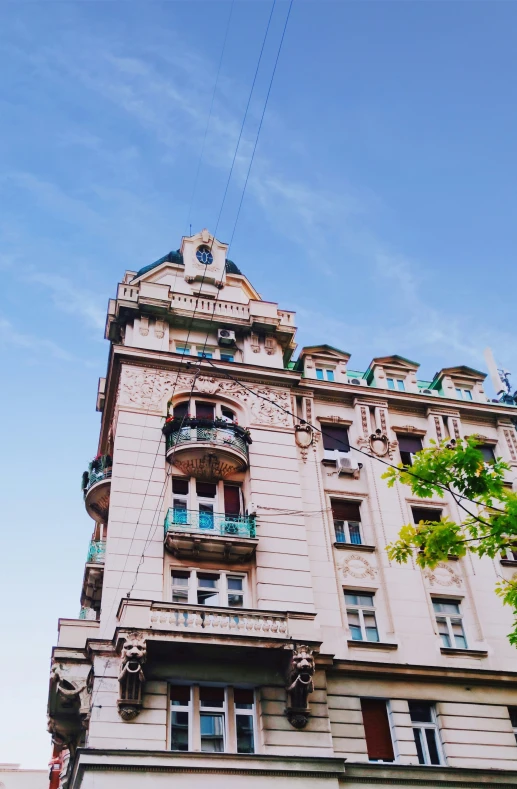 an old building with a balcony and many windows on top