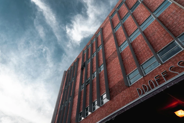 clouds fill the sky over a red brick building