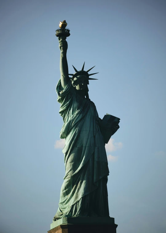 a tall statue with a torch in it's hand