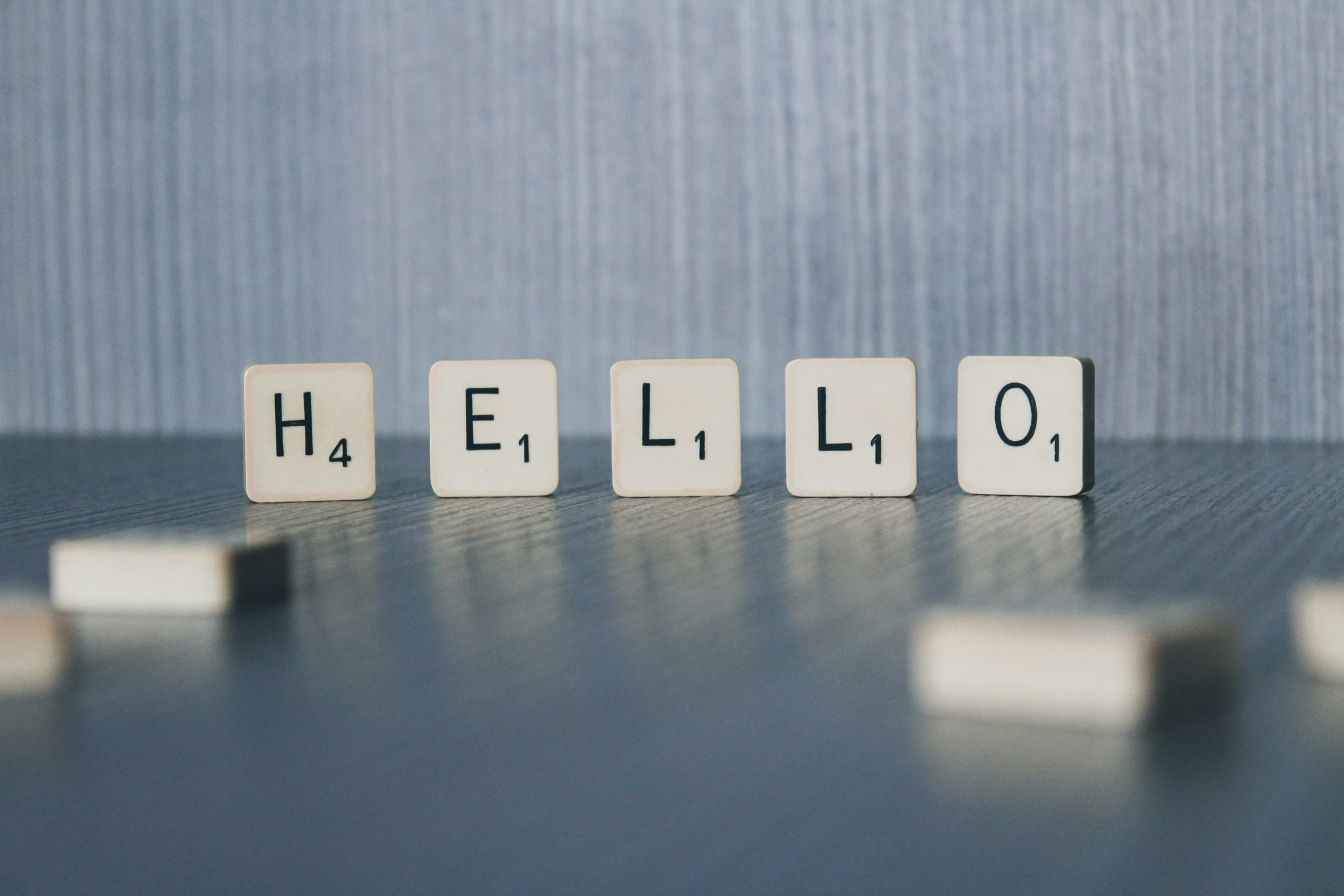 a small tile block spelling the word hello with white blocks