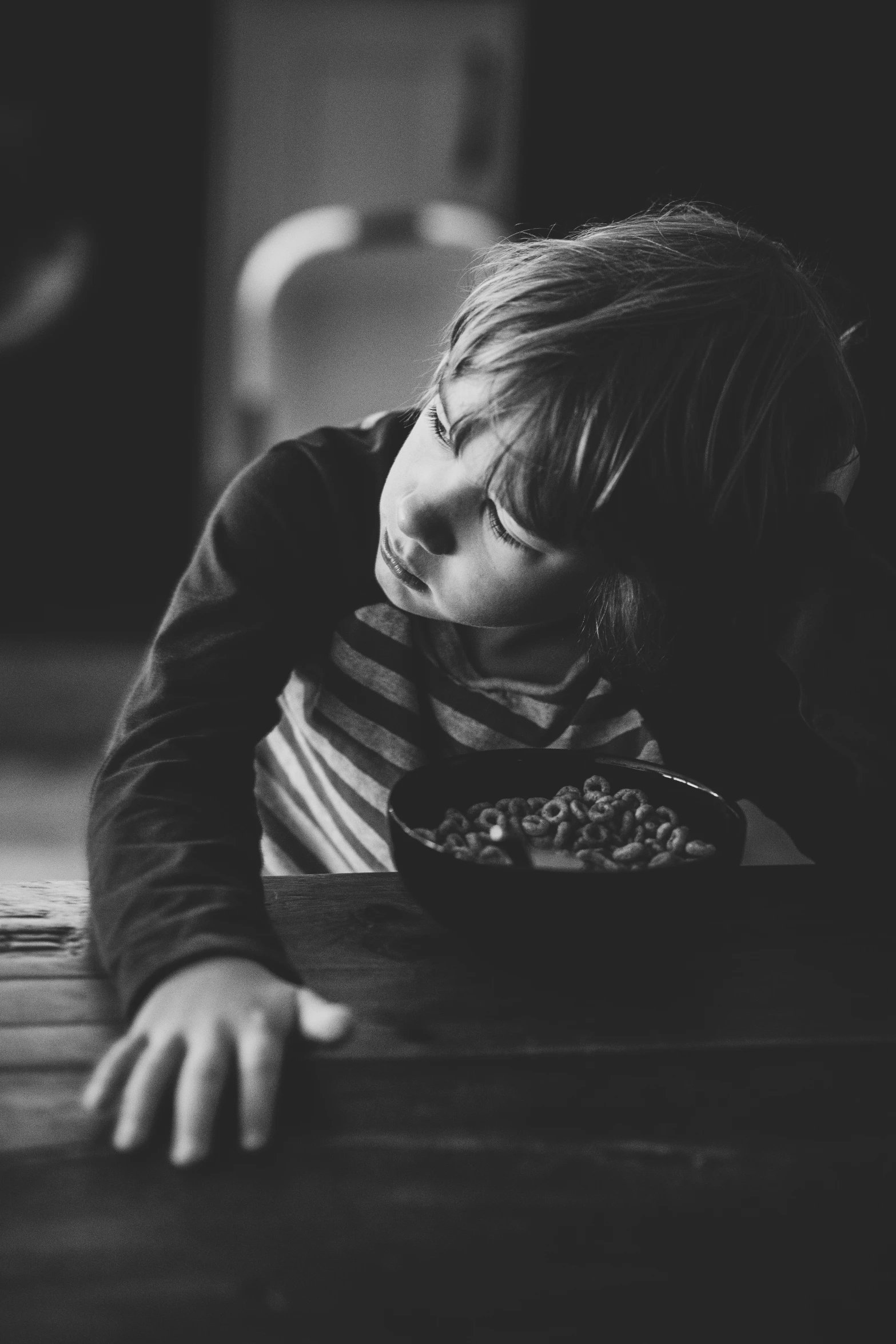 a boy with his head on a table