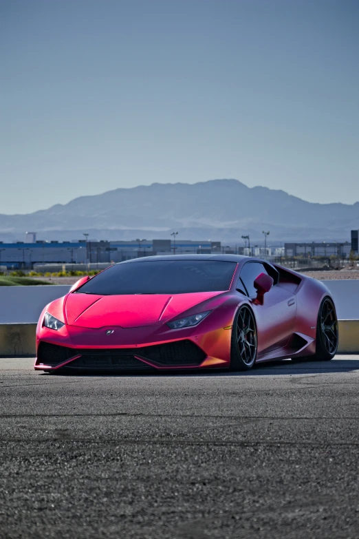 a pink sports car on a race track