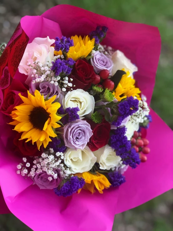 the bouquet of flowers is displayed in a hand