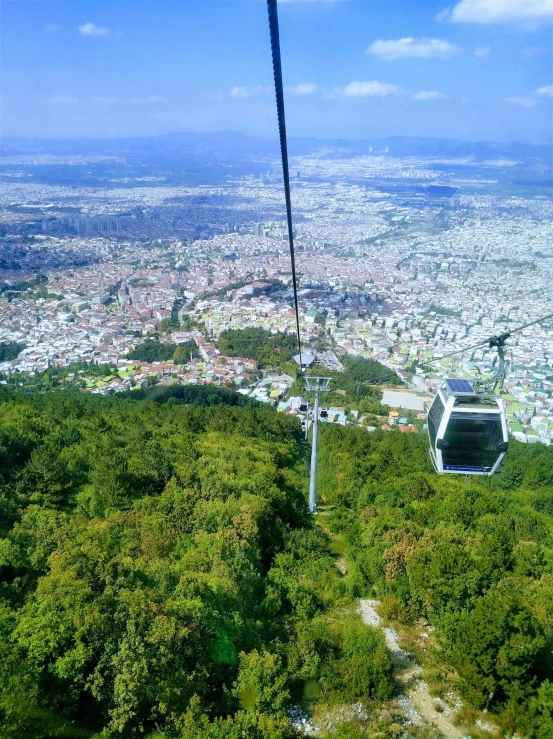 a chairlift sitting above a lush green valley