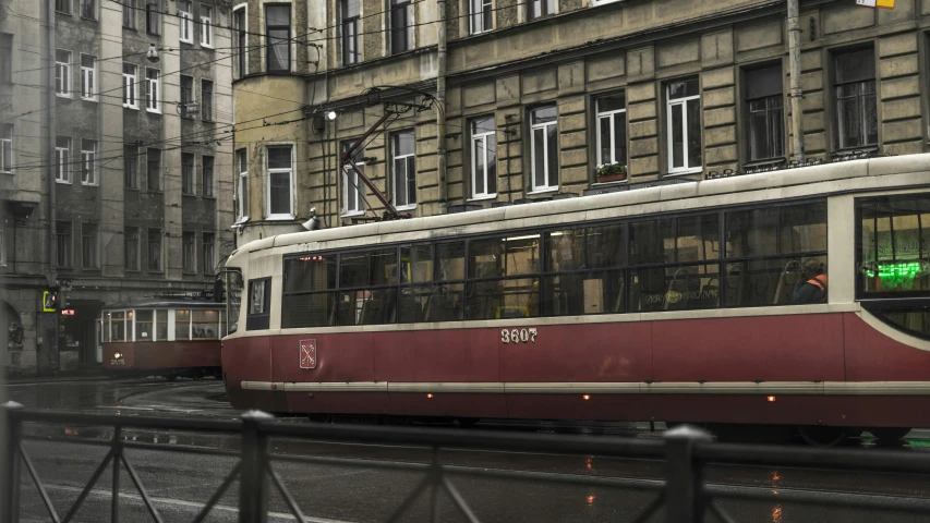 trolley driving through a very narrow city street