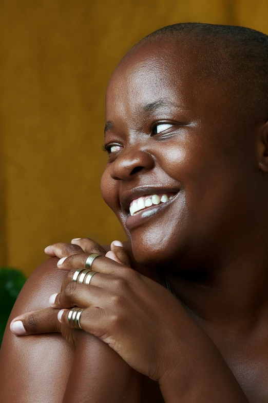 a woman with white makeup wearing three wedding rings