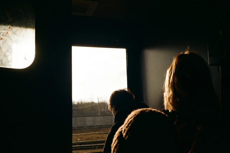 two women are in the window looking out at the tree