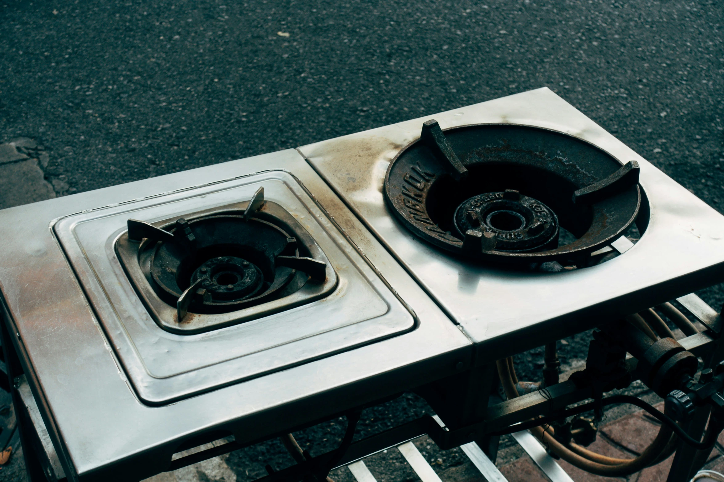 a couple of stoves sitting on top of a metal table