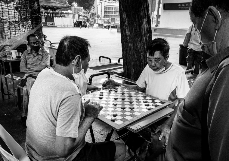 a man sitting at a table playing chess