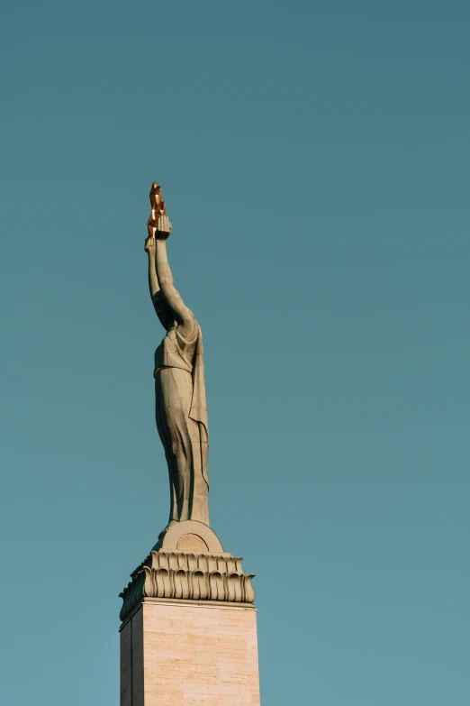 the large statue is holding up a child's finger