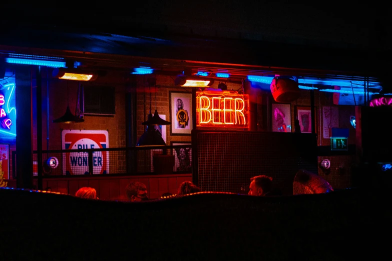 a bar lit up with neon lights in the dark