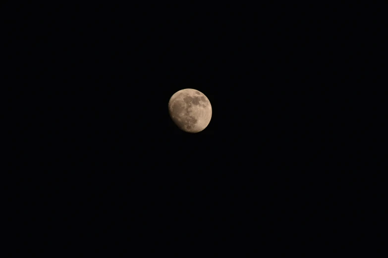 the moon with a black background looks out to sea