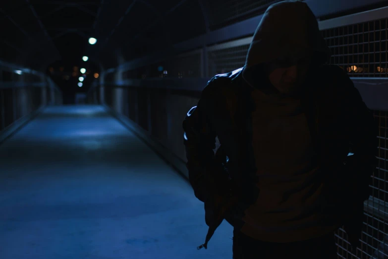 a man looking down a dark tunnel with some lights