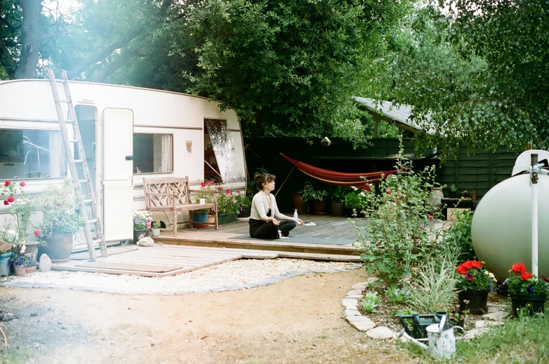 the small child is sitting on the outside of a trailer