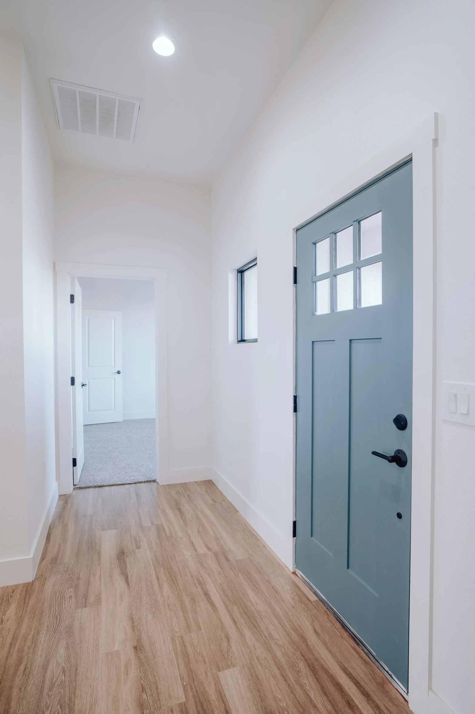 a large empty room with a door and an empty doorway