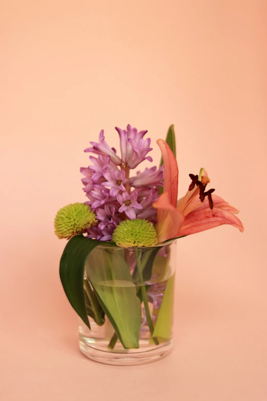 vase filled with lots of flowers on top of a table