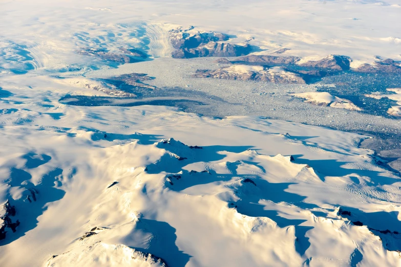 a snowy landscape with mountains and ice covered land