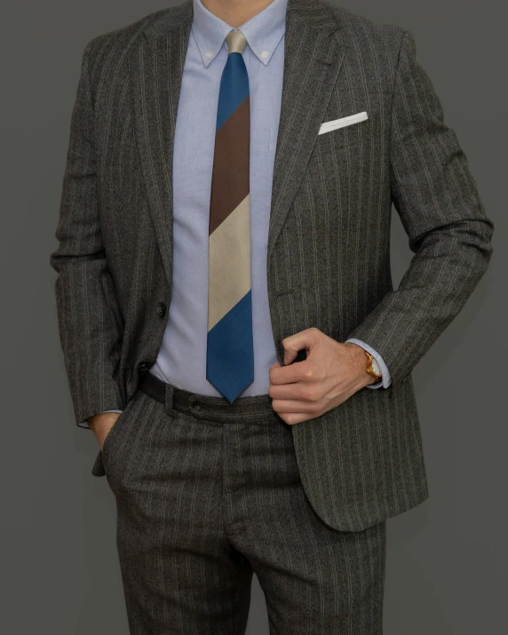 a man with a striped tie is posing for a picture