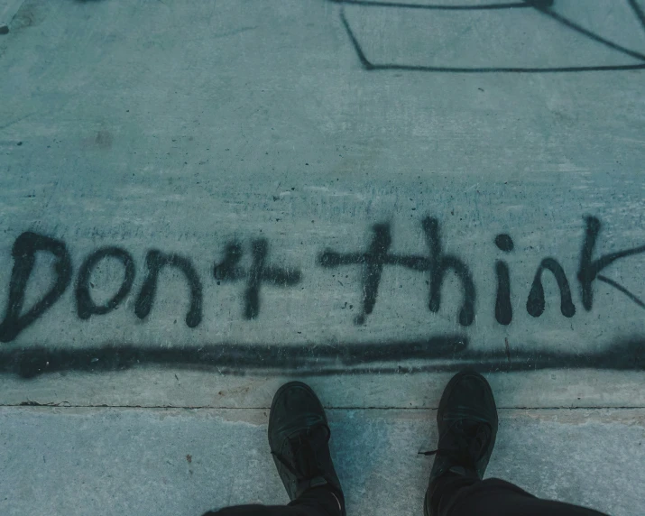 someone has written the words don't think on concrete