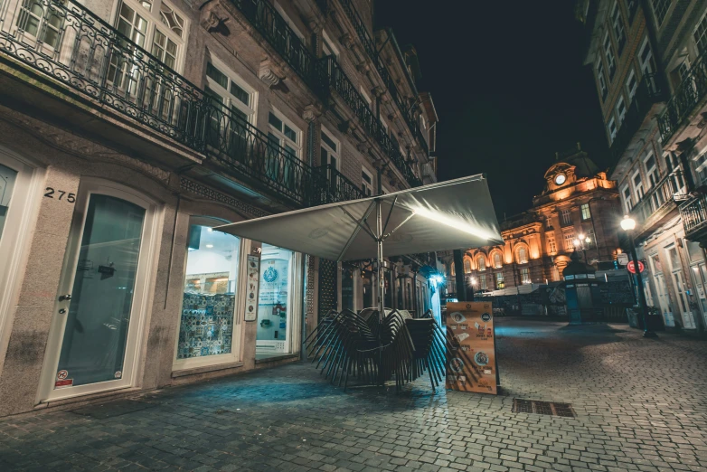 a building next to a street with stores