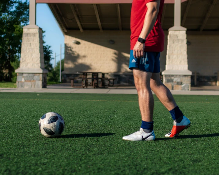 a person walking next to a soccer ball