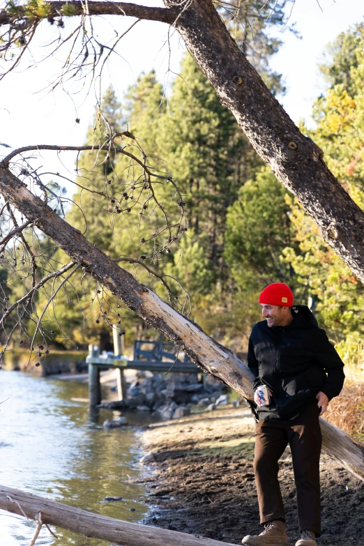 a person standing on a log over water