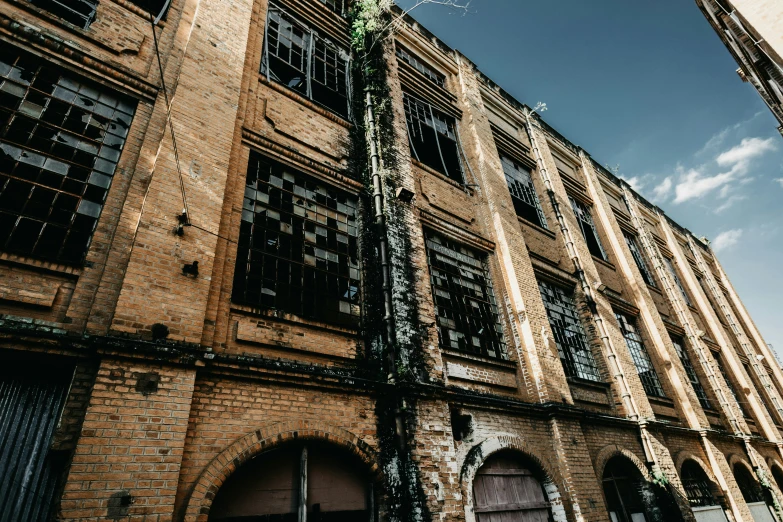 a tall building with iron bars near the window frames