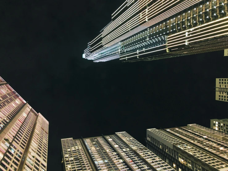 skyscrs seen from ground up at night