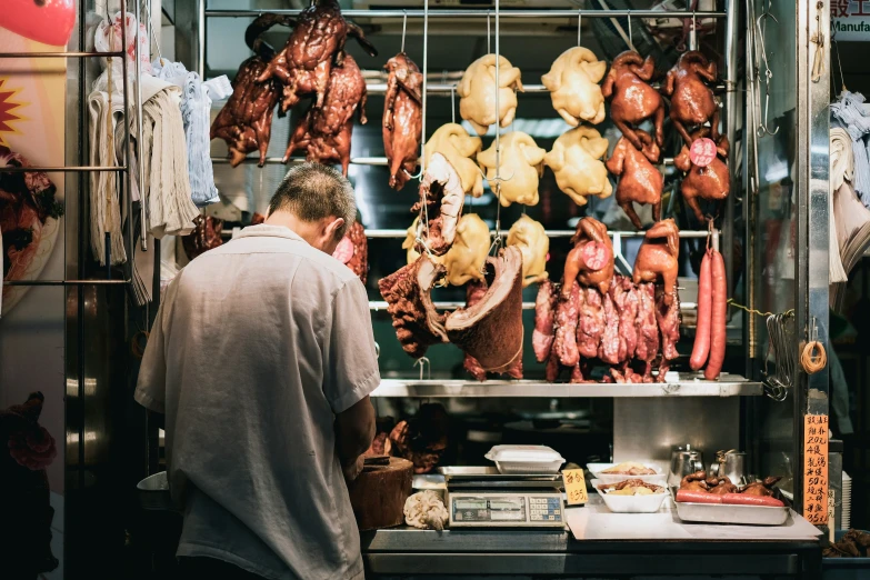 the man is cooking food in a grill