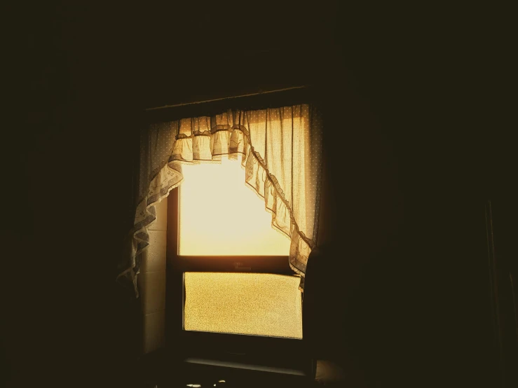 the dark, shadowy room has a light coming from a window