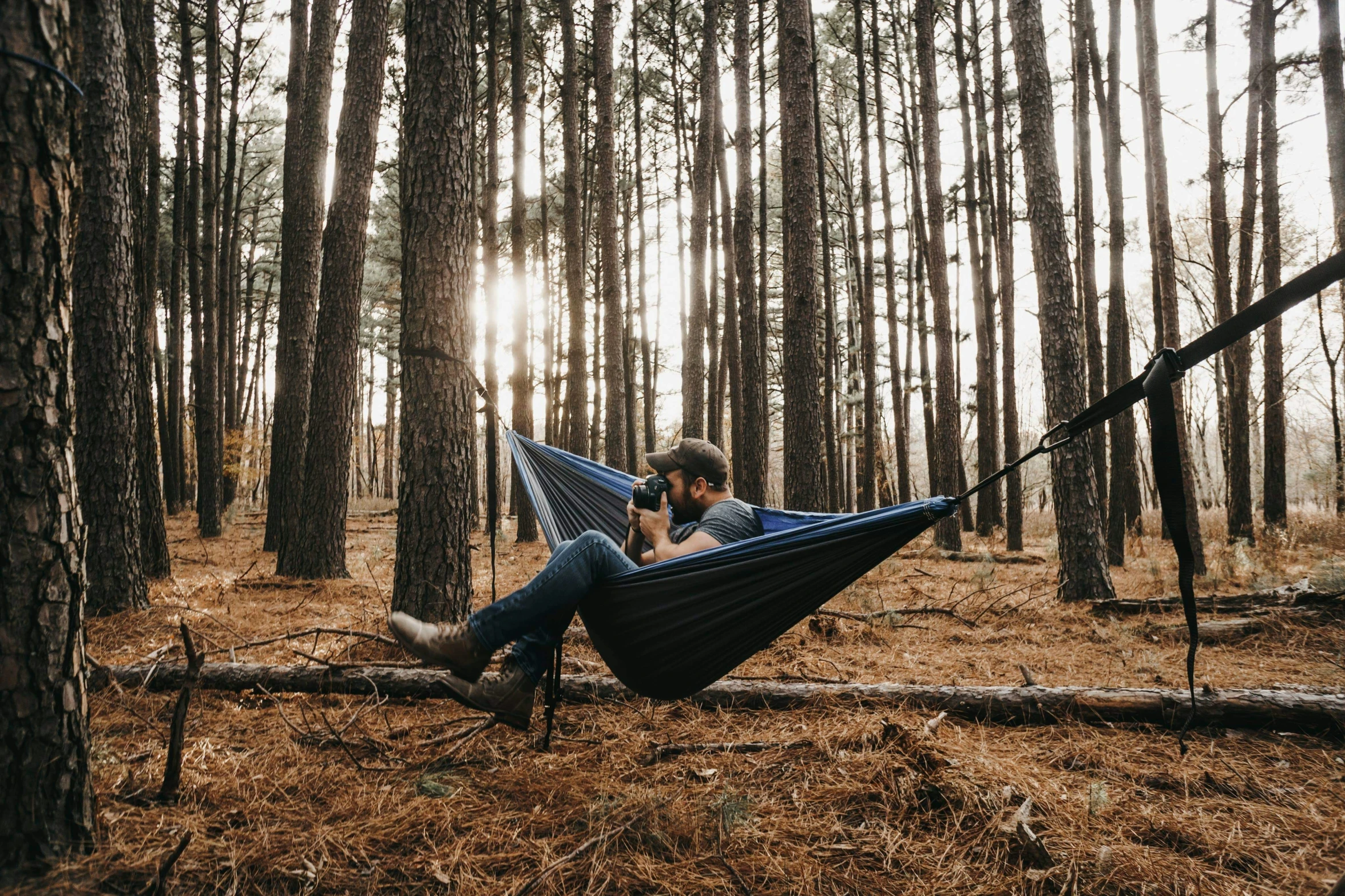 a man in a hammock reading a book