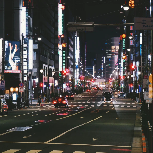 a city street filled with traffic at night