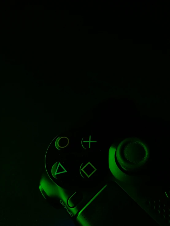 a close up of a game controller glowing in the dark