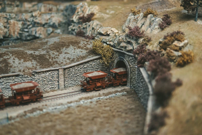 some small model train tracks with cars going down it